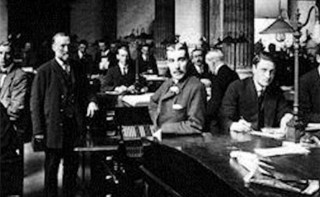 Black and white image of men in an office of the past